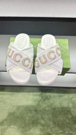 Gucci White Logo Slide Sandals – Embossed "GUCCI" Lettering, Cross-Band Design, Premium Leather